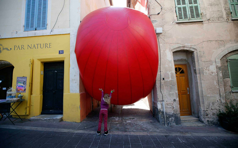 Масеј - Дијете се игра великим балоном који је постављен између двије грађевине   (Фото:REUTERS/Jean-Paul Pelissier )